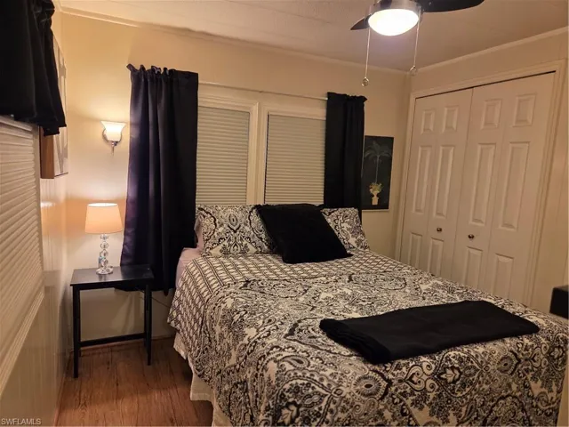 Ceiling fan, double closets, and laminate floor in the Primary bedroom.