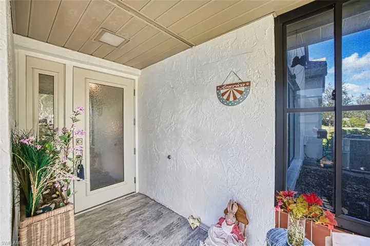 Property entrance with stucco siding