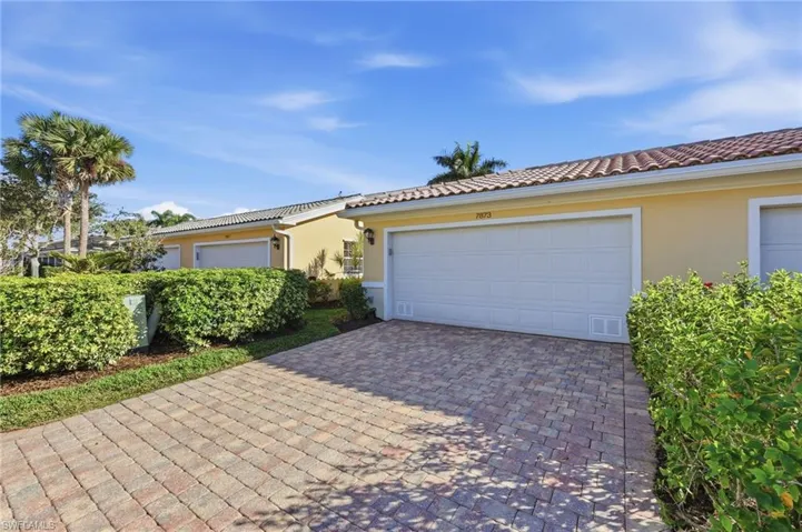 View of front of house featuring stucco siding, decorative driveway, and a tile roof