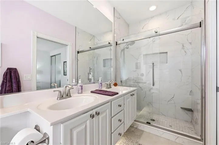 Master Bathroom with double vanity, upgraded Glass and marble finish shower, and recessed lighting