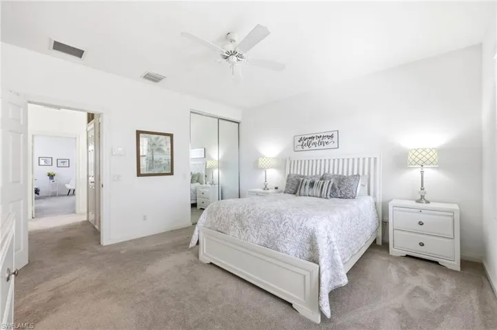 Master Bedroom featuring light carpet, a closet, and a ceiling fan