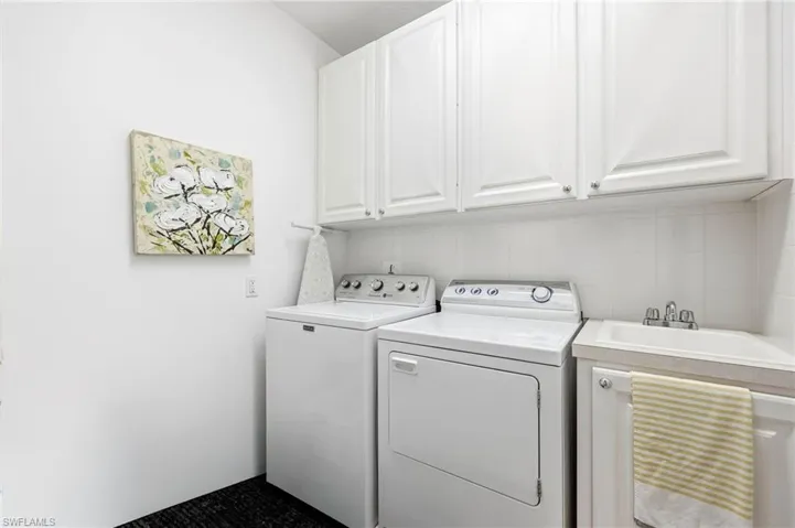 Laundry room with cabinet space and washing machine and dryer