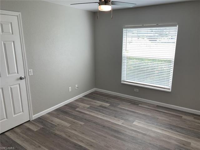 This is the second guest bedroom, notice the luxury vinyl flooring, new ceiling fans, new hurricane impact windows, large walk in closet, etc.