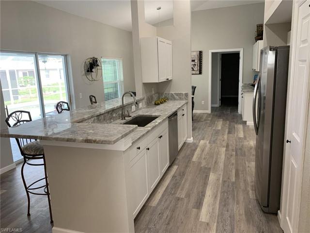 The kitchen sink overlooks the pool and the family room.   The same new flooring runs thoughout the home.