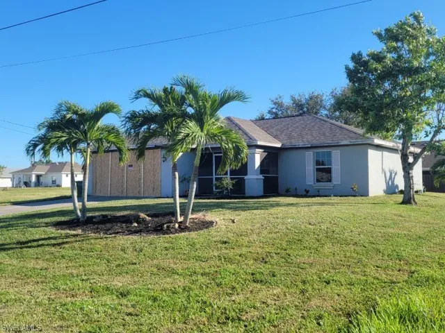 Ranch-style home with a front lawn
