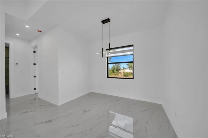 Unfurnished room with light marble finish floors and recessed lighting