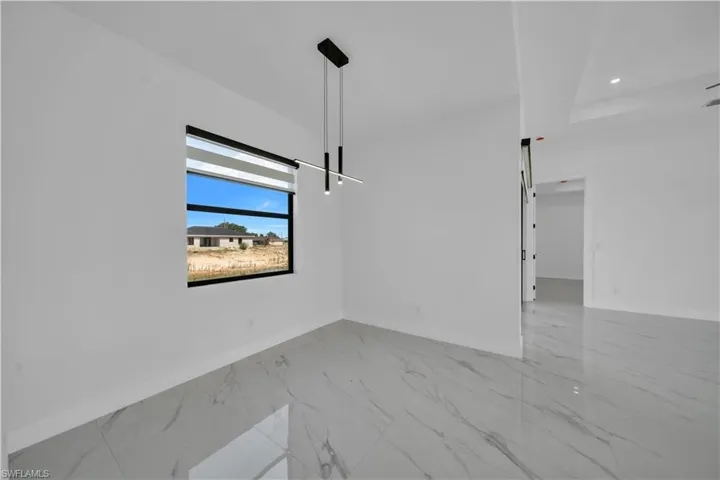 Unfurnished dining area with light marble finish floors and recessed lighting