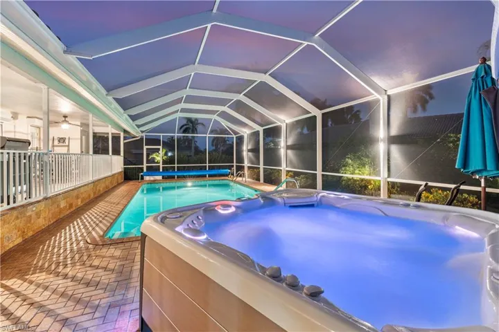 enclosure, a hot tub, and a patio area