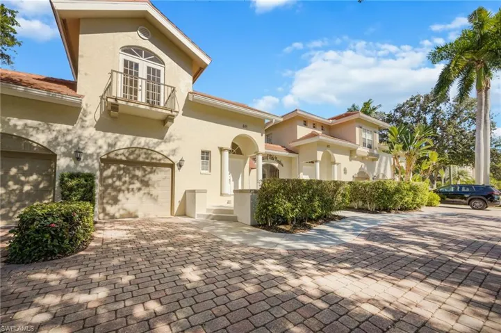 Mediterranean / spanish-style home with stucco siding, a balcony, decorative driveway, and a garage