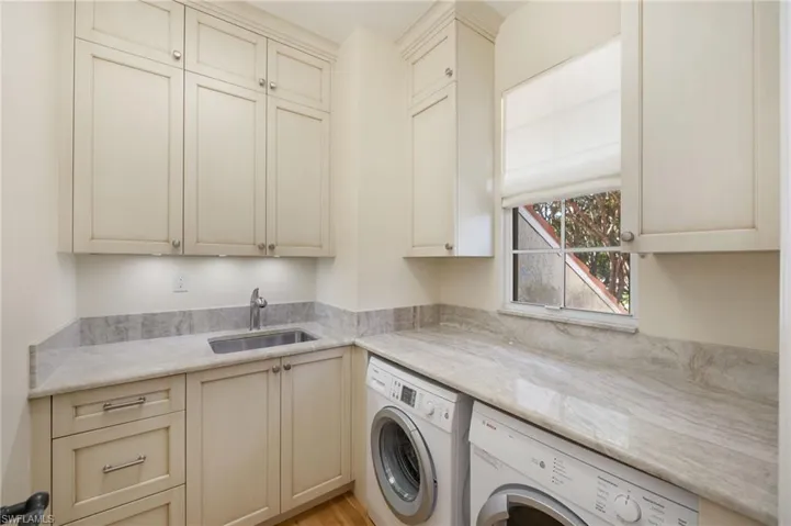 Washroom with cabinet space and washer and dryer