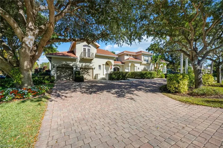 Mediterranean / spanish-style house with decorative driveway and stucco siding