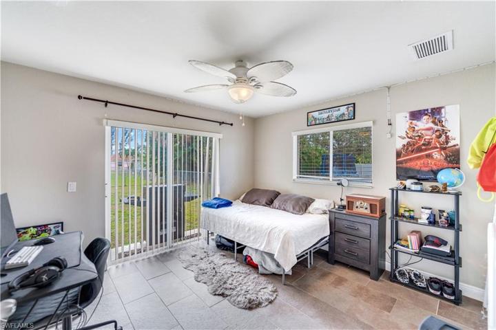 Bedroom with sliders to backyard