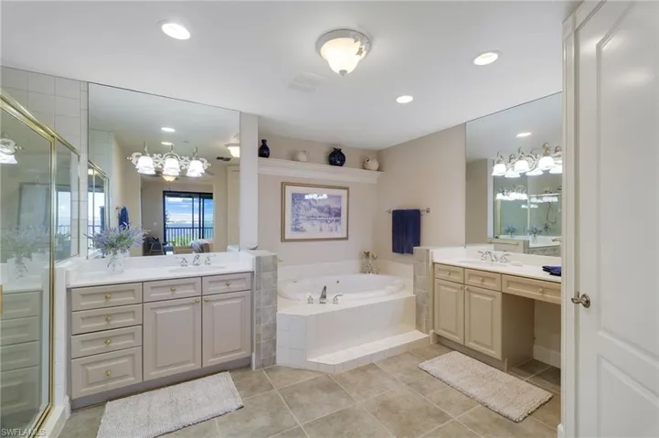 Primary Ensuite Bathroom features jacuzzi tub, dual vanities and oversized shower stall.