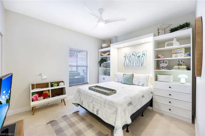 Bedroom featuring ceiling fan and light tile patterned flooring