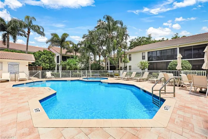 View of swimming pool with a patio and a community hot tub