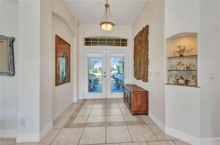 Entrance foyer with french doors and baseboards