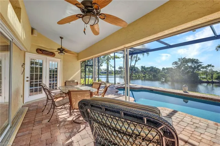 Lots of "under cover" space on the lanai a water view, ceiling fan, a swimming pool, and outdoor dining area