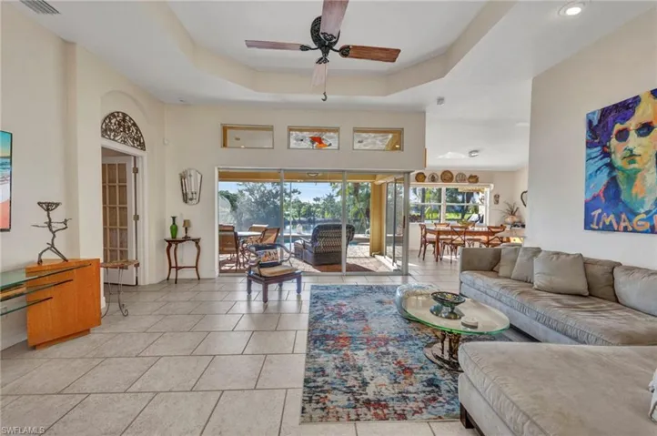 Living room with plenty of natural light, ceiling fan, recessed lighting, and light tile patterned floors