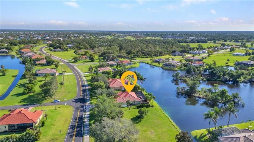Aerial view of residential area featuring a nearby body of water