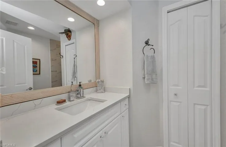 Second Bathroom featuring a closet, vanity, recessed lighting, and a shower