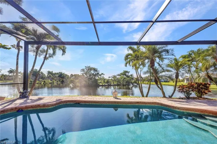Swimming pool featuring a water view and a lanai