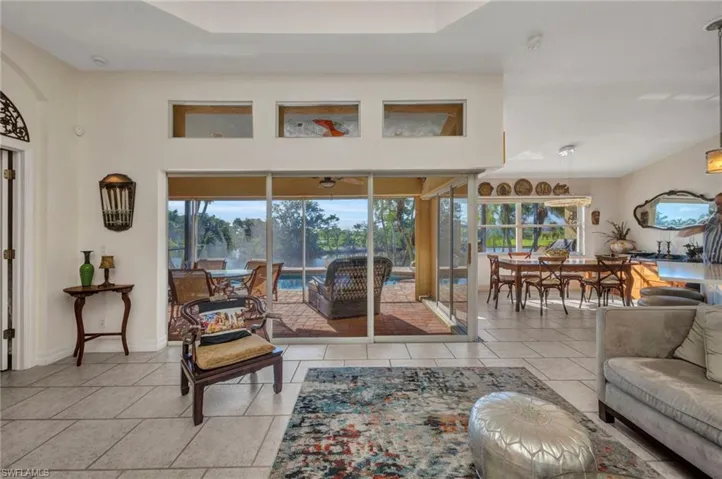Living room with light tile patterned floors and baseboards