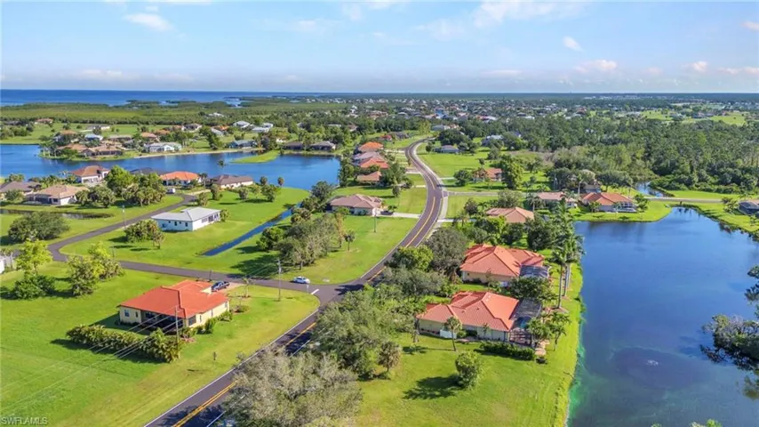 Aerial view of residential area featuring a nearby body of water