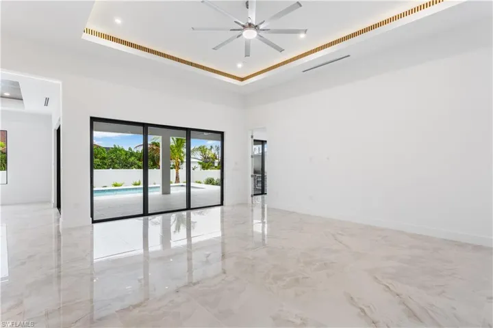 Indulge in the WARMTH OF HOME beneath the 16-ft COVE CEILING, also adorned with ACOUSTIC PANELS and LED indirect lights, creating a SERENE atmosphere perfect for RELAXATION and ENTERTAINMENT alike.