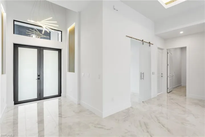 Walk through FRONT PORCH & enter DOUBLE FRONT DOORS, you're greeted by GRAND FOYER adorned w/ ACOUSTIC PANELS EMBEDDED w/ LED TRACK LIGHTS, setting stage for TRULY CAPTIVATING AMBIANCE!