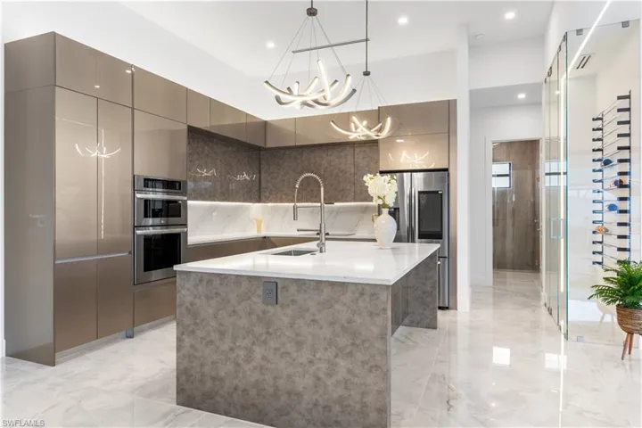The GOURMET KITCHEN stands as the HEART of this home, inviting FAMILY GATHERINGS and INTIMATE CONVERSATIONS