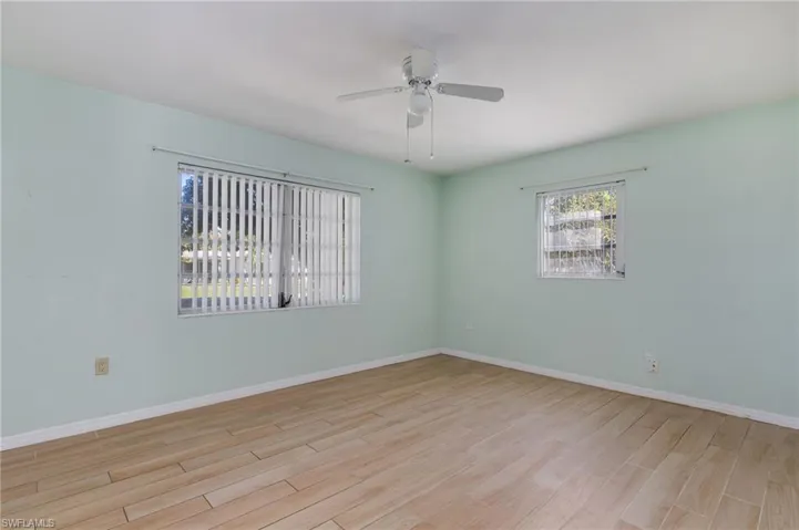 Unfurnished room with light wood finished floors and ceiling fan