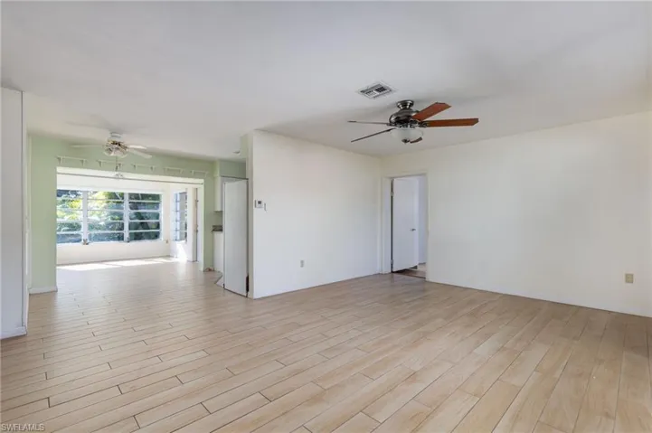 Spare room with a ceiling fan and light wood finished floors