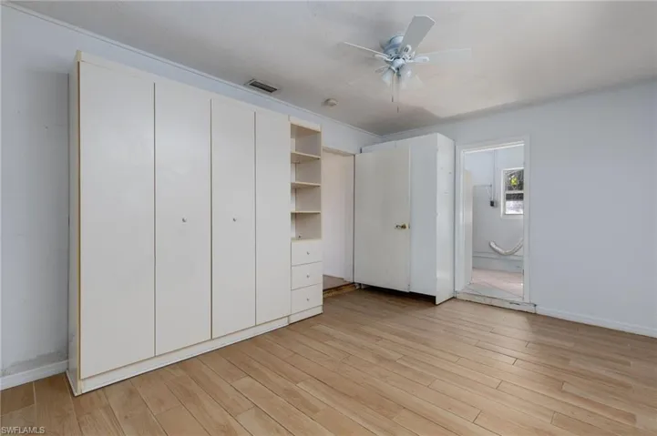 Unfurnished bedroom with light wood finished floors and ceiling fan