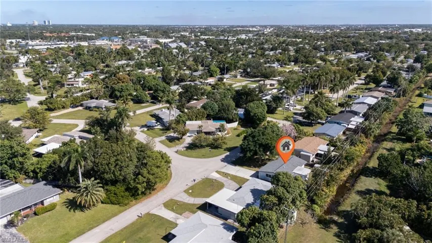 Aerial overview of property's location with nearby suburban area