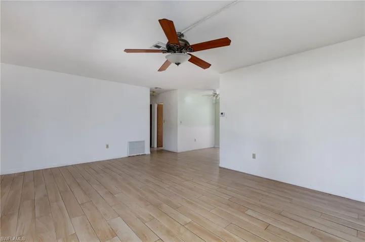Unfurnished room with light wood-style flooring and a ceiling fan