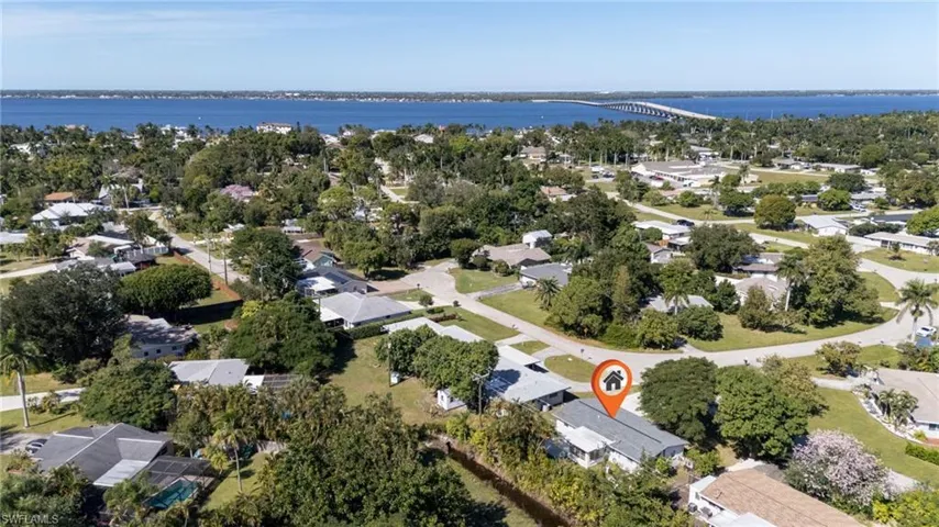 Aerial view of property and surrounding area with a notable bridge, nearby suburban area, and a nearby body of water