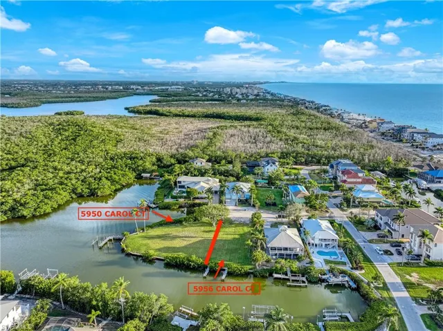 Aerial perspective of suburban area featuring a large body of water