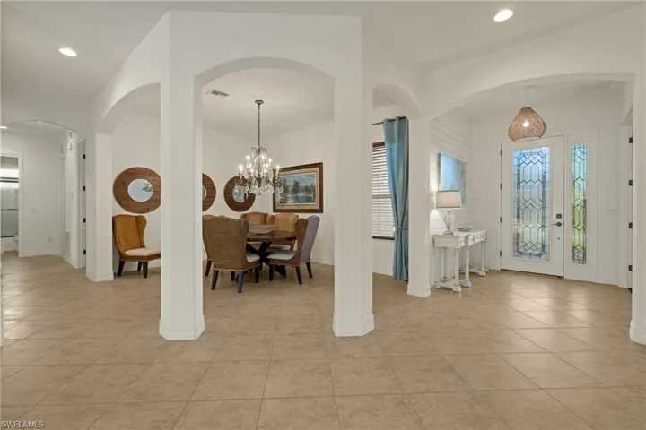 Entrance foyer featuring light tile patterned floors, recessed lighting, and arched walkways