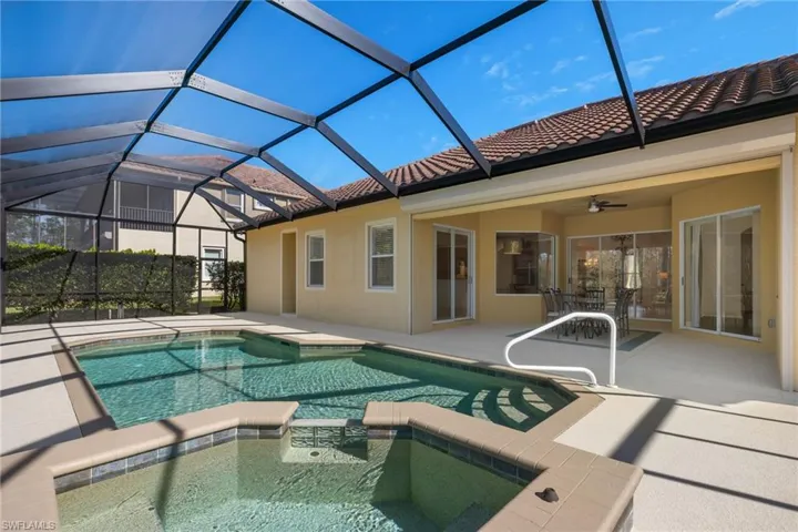 View of swimming pool with a patio area, a pool with connected hot tub, ceiling fan, and a lanai