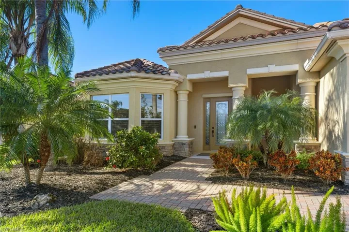 Doorway to property featuring stucco siding and a tile roof