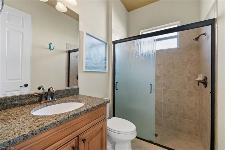 Full bathroom with vanity and a stall shower