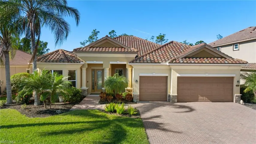 Mediterranean / spanish house featuring a garage, decorative driveway, stucco siding, stone siding, and a tiled roof