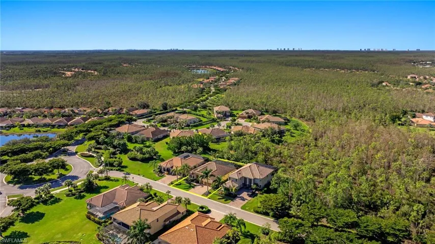 Aerial view of residential area with a heavily wooded area