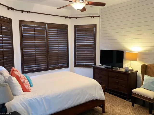 Bedroom with ceiling fan and carpet