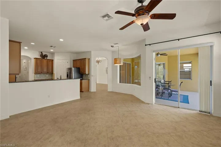 Unfurnished living room with a ceiling fan, recessed lighting, and arched walkways