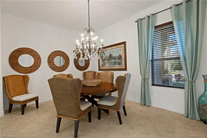 Dining area with a chandelier and light tile patterned flooring