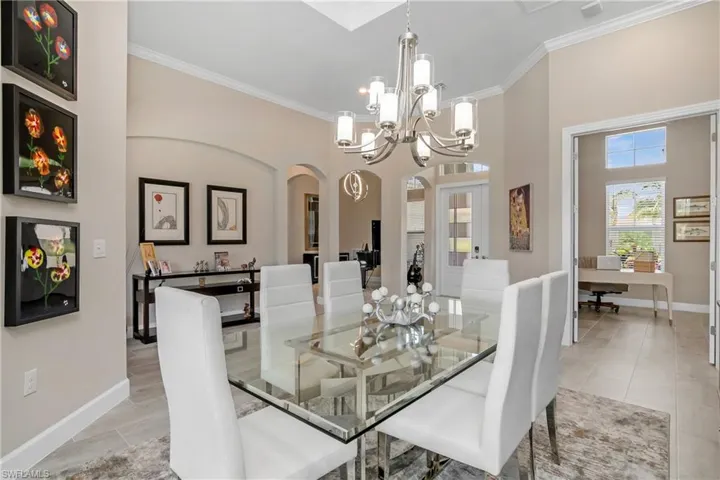Additional view of dining space, entry foyer, and den with french doors.