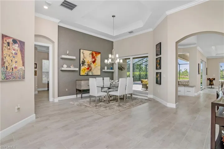 You'll love the custom accent wall in the open dining area, and elegant designer chandelier.