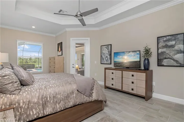 Owner suite includes a sitting area as well as a door leading to the pool/spa and outdoor lanai.
