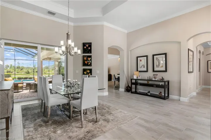 Formal dining room is versatile and features soaring tray ceilings, crown molding, and beautiful arches giving this home character and elegance.